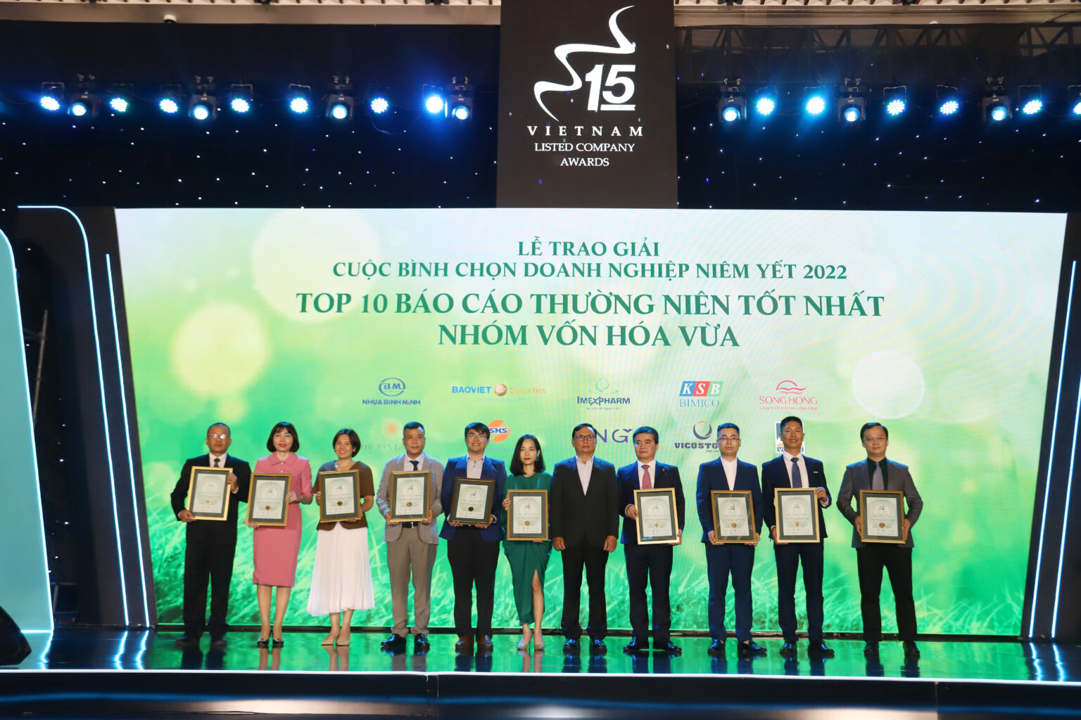 Imexpharm representative receiving Top 10 Best Annual Report certificate on stage